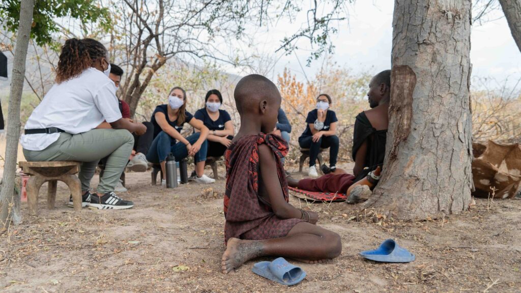 Global Pre-Meds visit locals kid